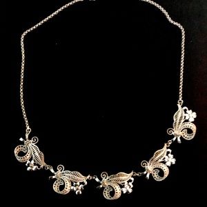 Choker style ornate design silver necklace.